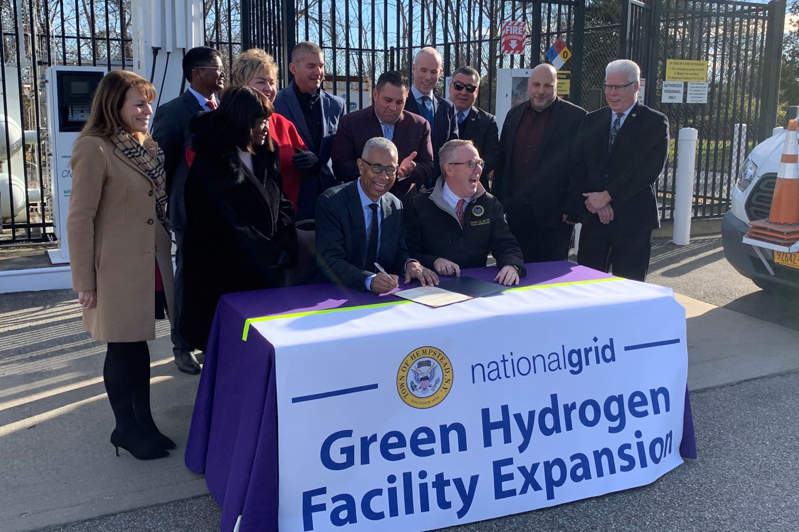 Group of officials at a table signing documents for the Green Hydrogen Facility Expansion by nationalgrid.